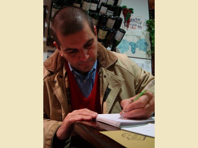 Paolo signs a book...